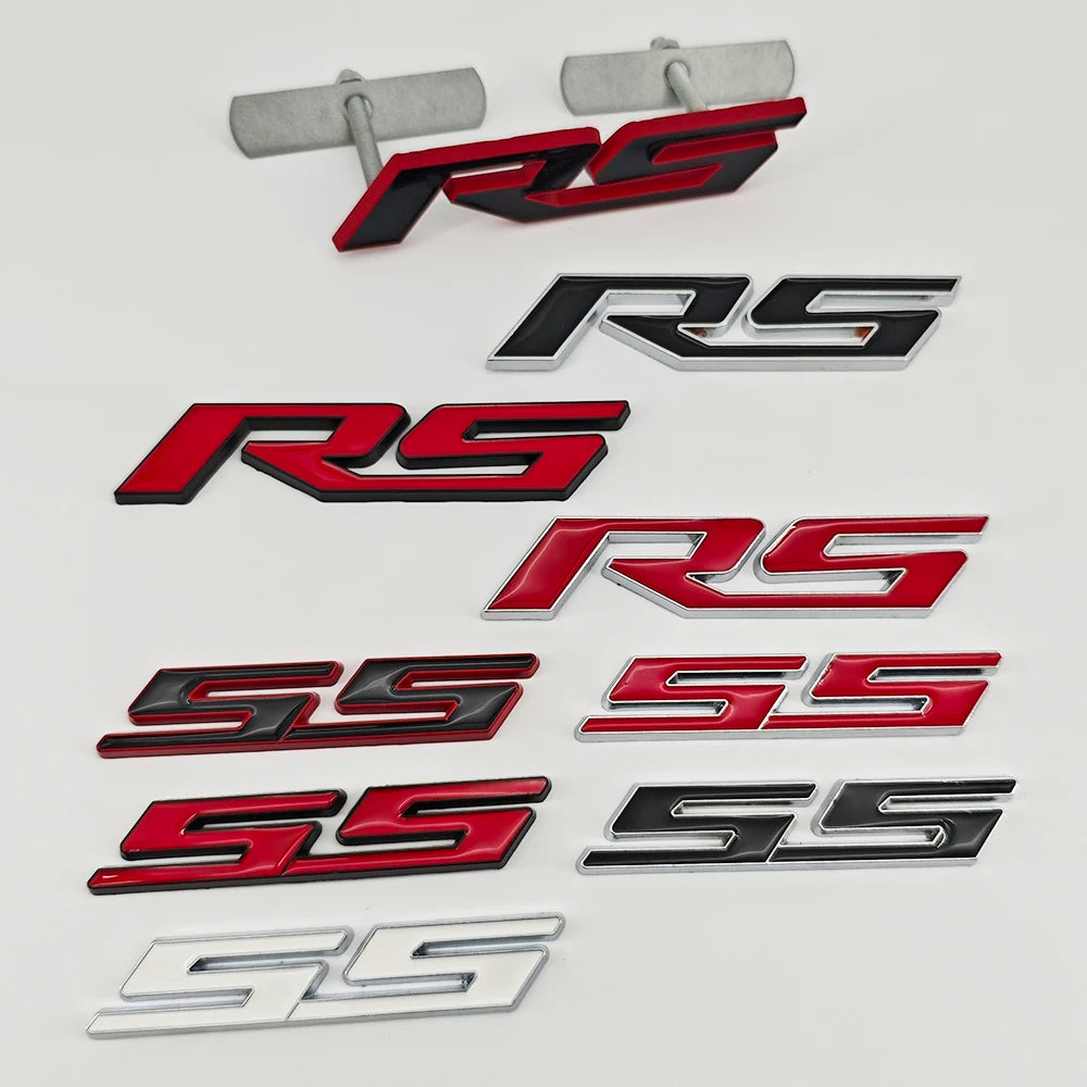 A collection of 3D metal SS and RS emblem badges in black, red, and silver finishes.