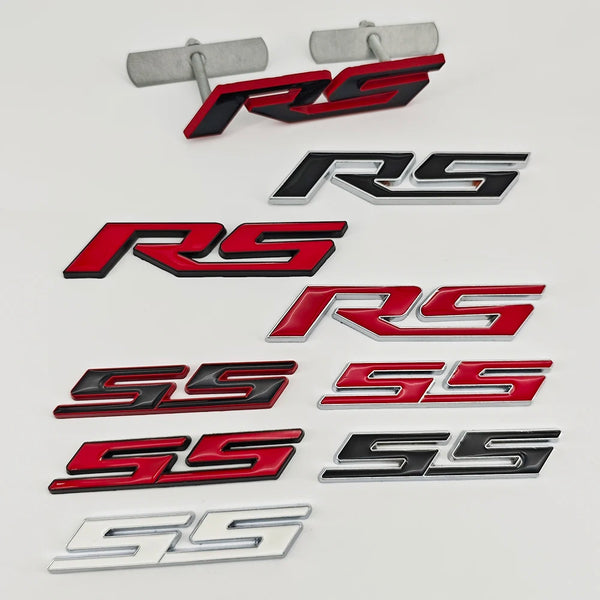 A collection of 3D metal SS and RS emblem badges in black, red, and silver finishes.