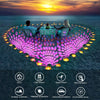 A multi-mode USB projection party light illuminating a heart shape with colorful lights against the ocean backdrop.