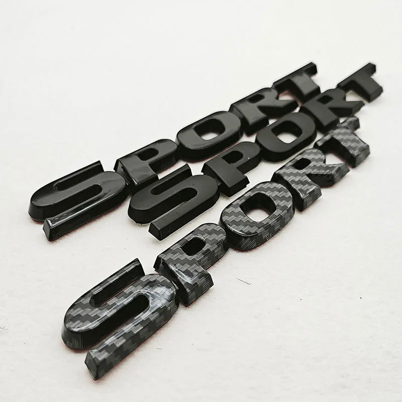 A set of black 3D chrome car logo emblems spelling out SPORT arranged in a line.