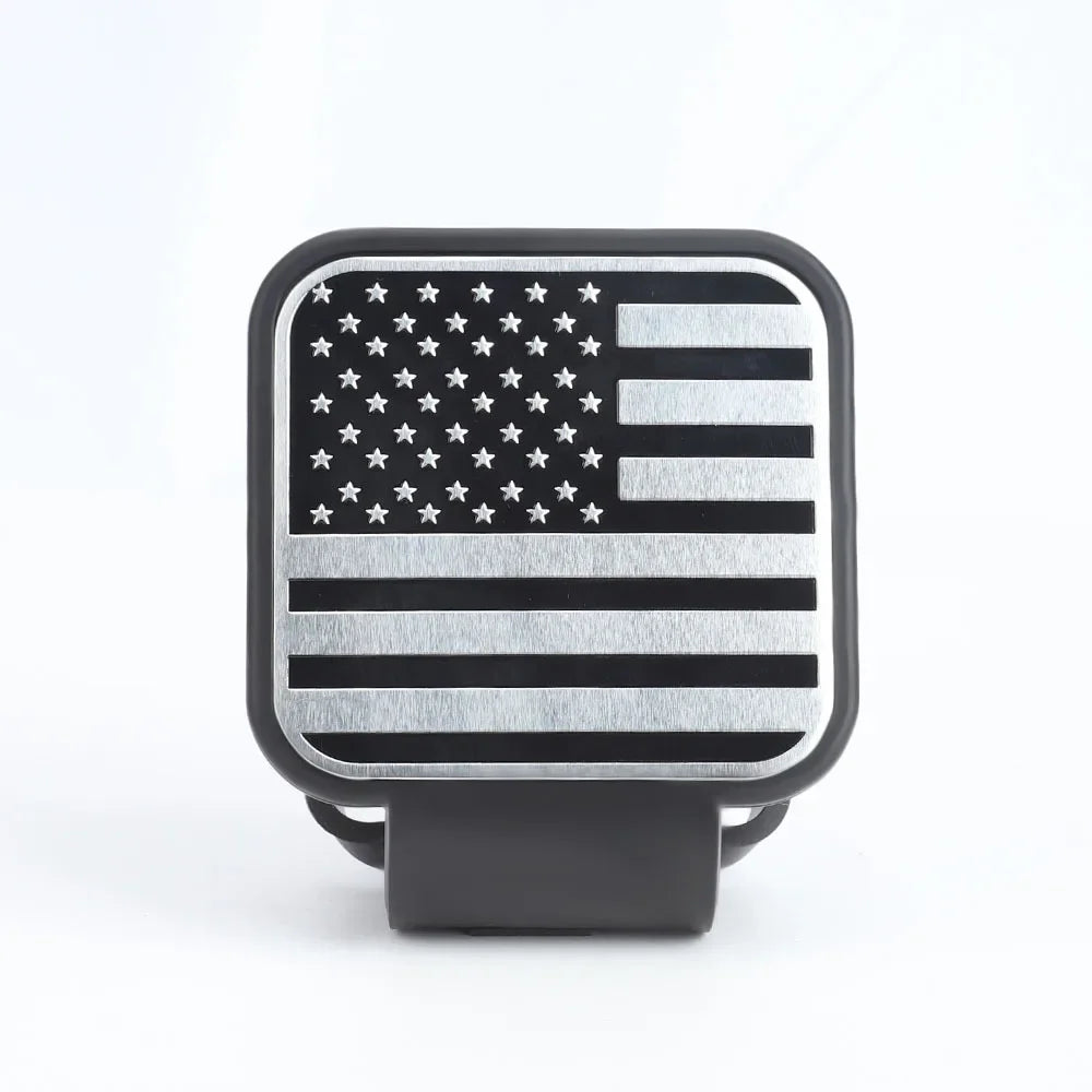 A black square universal trailer hitch cover featuring a silver American flag design.