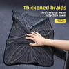 A hand is touching a black thickened braid professional water collection towel used for car drying.