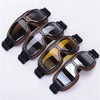 A pair of brown leather retro folding motorcycle windproof glasses with dark tinted lenses.