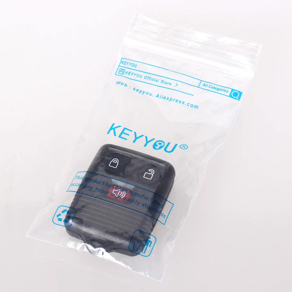 A clear plastic bag containing a black universal remote car key transmitter.
