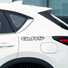 A white car is shown with a black vinyl decal that reads GUTS on the side panel.