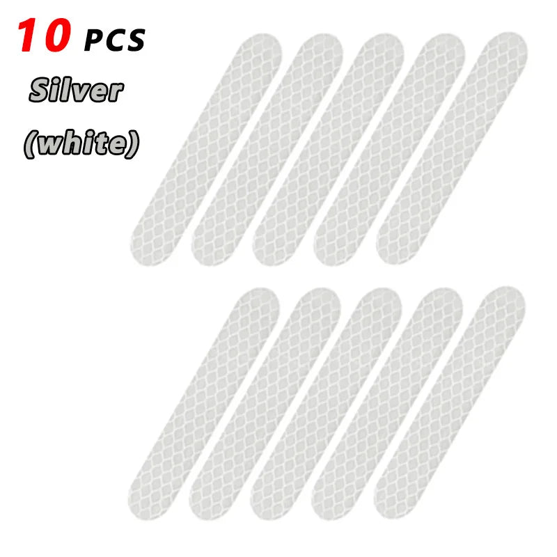 Ten silver reflective safety stickers or tape pieces.