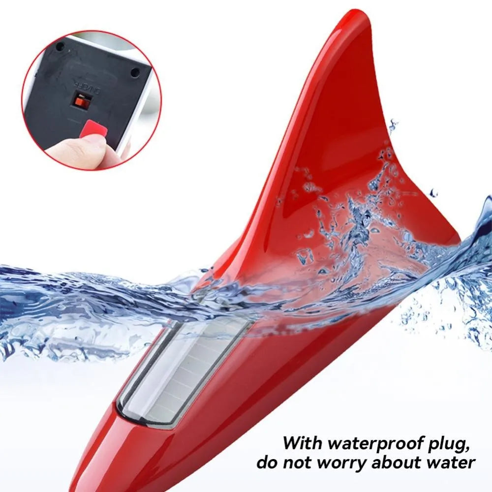 A red solar powered LED warning tail light antenna with a waterproof plug, shown in action with water splashing.