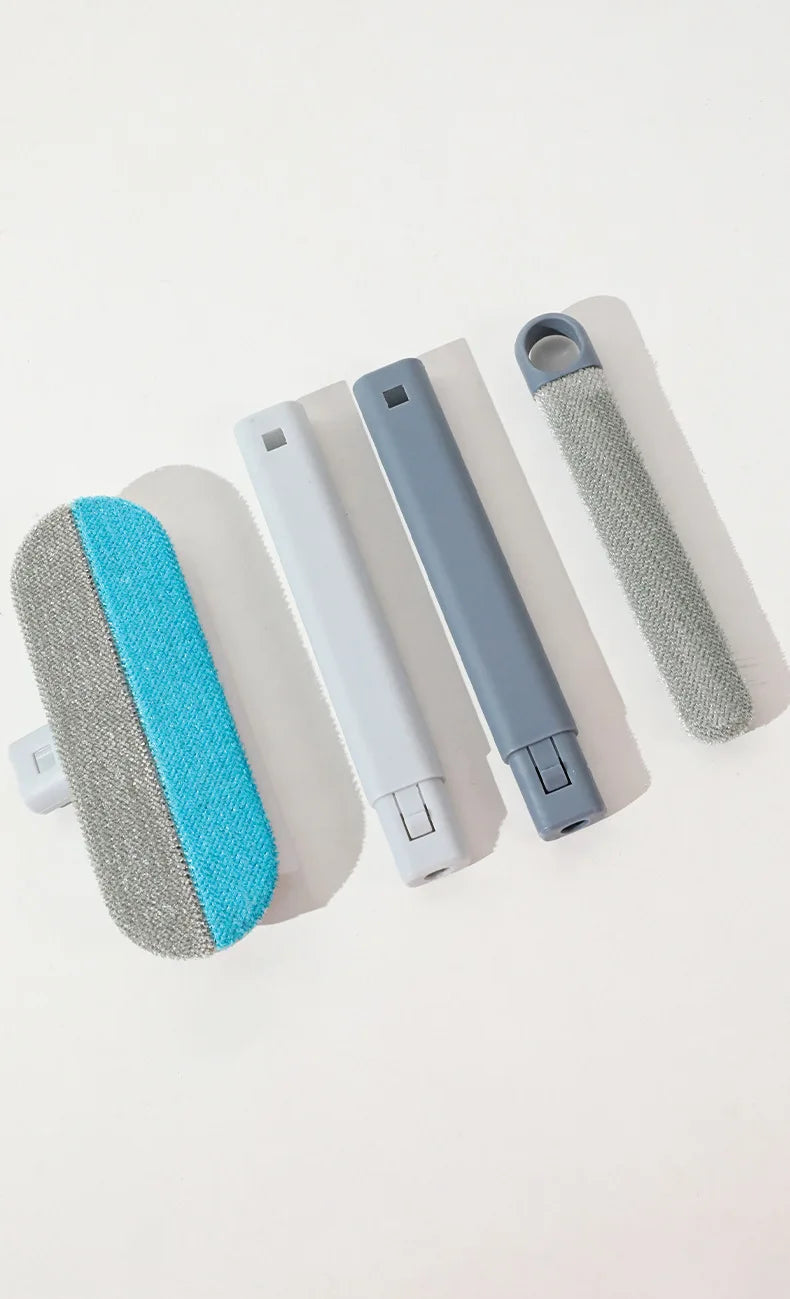 A set of long-handled static pet hair remover brushes in various colors including blue, gray, and white.