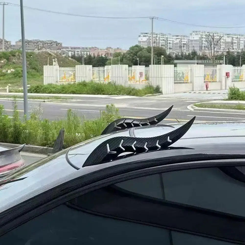 Black dragon horn roof decor installed on a car windshield.