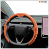 Orange steering wheel cover for a car, shown inside the vehicle