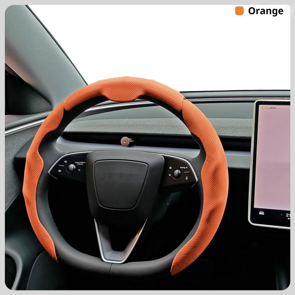 Orange steering wheel cover for a car, shown inside the vehicle