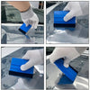 A hand is using a blue and black professional window tint installation tool kit to apply film to a car window.