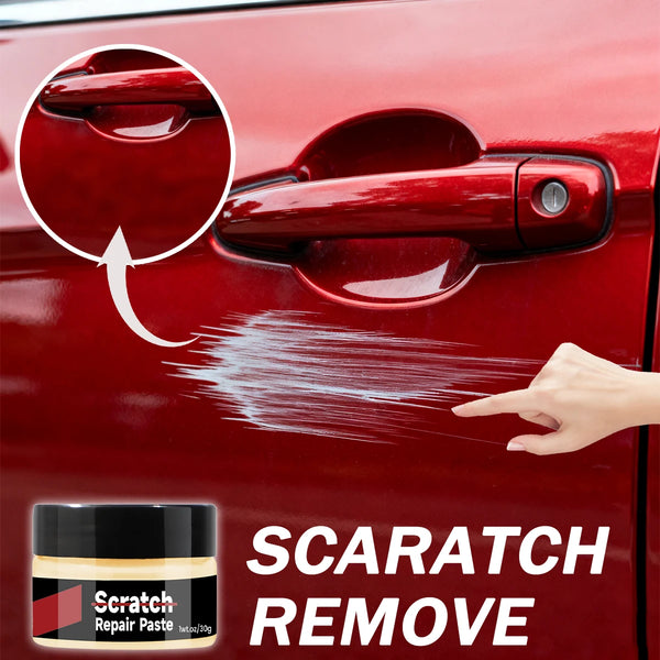 A hand is applying a red repair paste to a red car door to remove scratches.