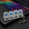 A clear plastic keychain featuring multiple clickable LED keyboard fidget toys attached to a silver metal ring.