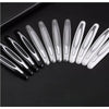 A row of metallic silver and black car door edge protection strips arranged diagonally on a dark surface.
