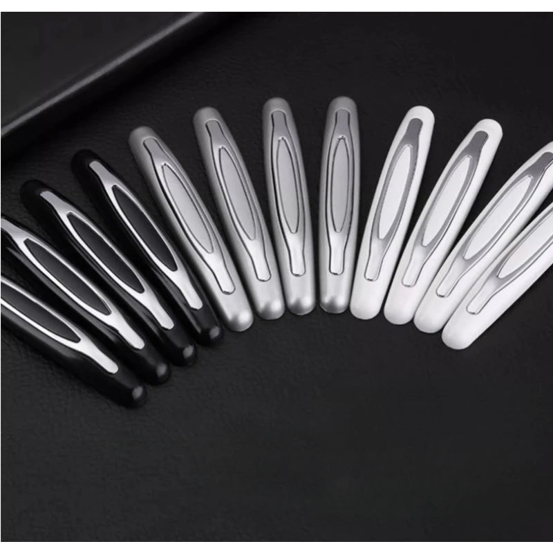 A row of metallic silver and black car door edge protection strips arranged diagonally on a dark surface.