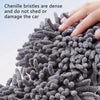 Close-up of dense gray chenille bristles being used to clean a car surface.