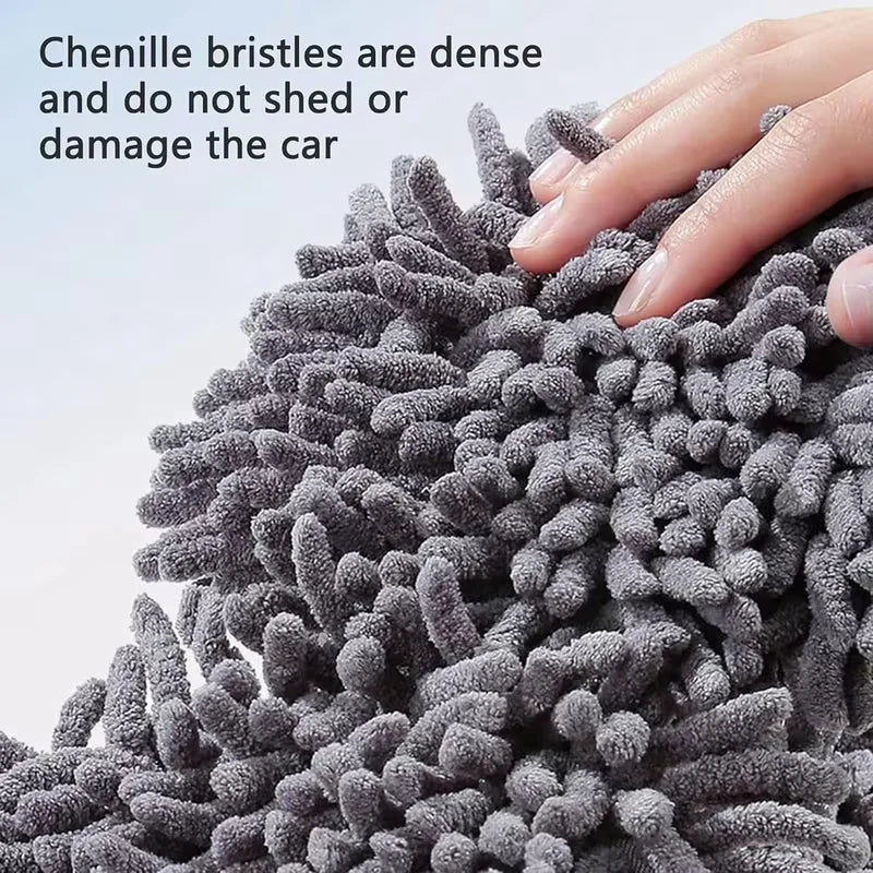 Close-up of dense gray chenille bristles being used to clean a car surface.