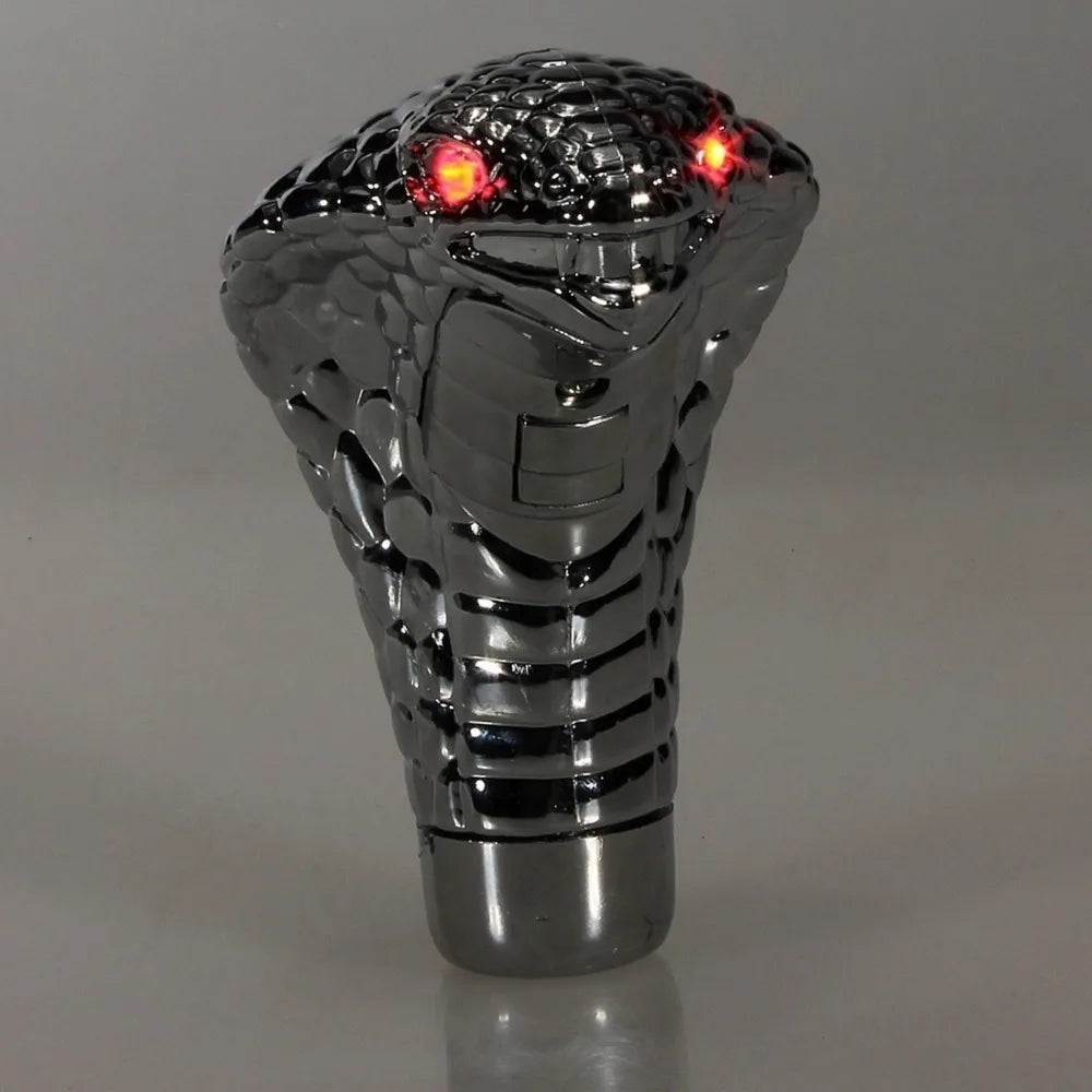 A silver Cobra Snake LED gear shift knob for manual transmissions with glowing red lights.