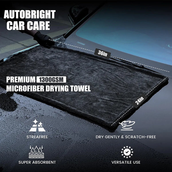 A black microfiber drying towel is shown being used on a car surface, highlighting its features like streak-free and absorben