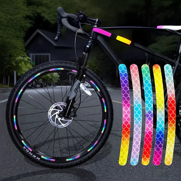 A bicycle wheel with multi-color reflective safety stickers on the spokes and a black frame.