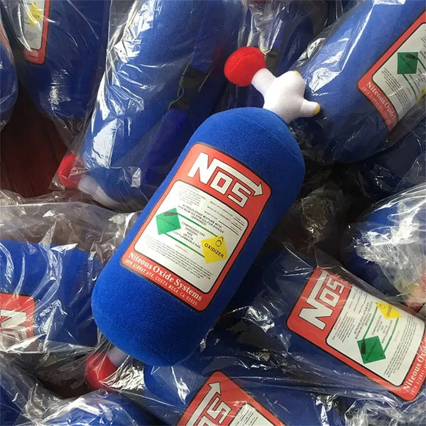 A blue nitrous oxide bottle with a white pillow attached, packaged in clear plastic.