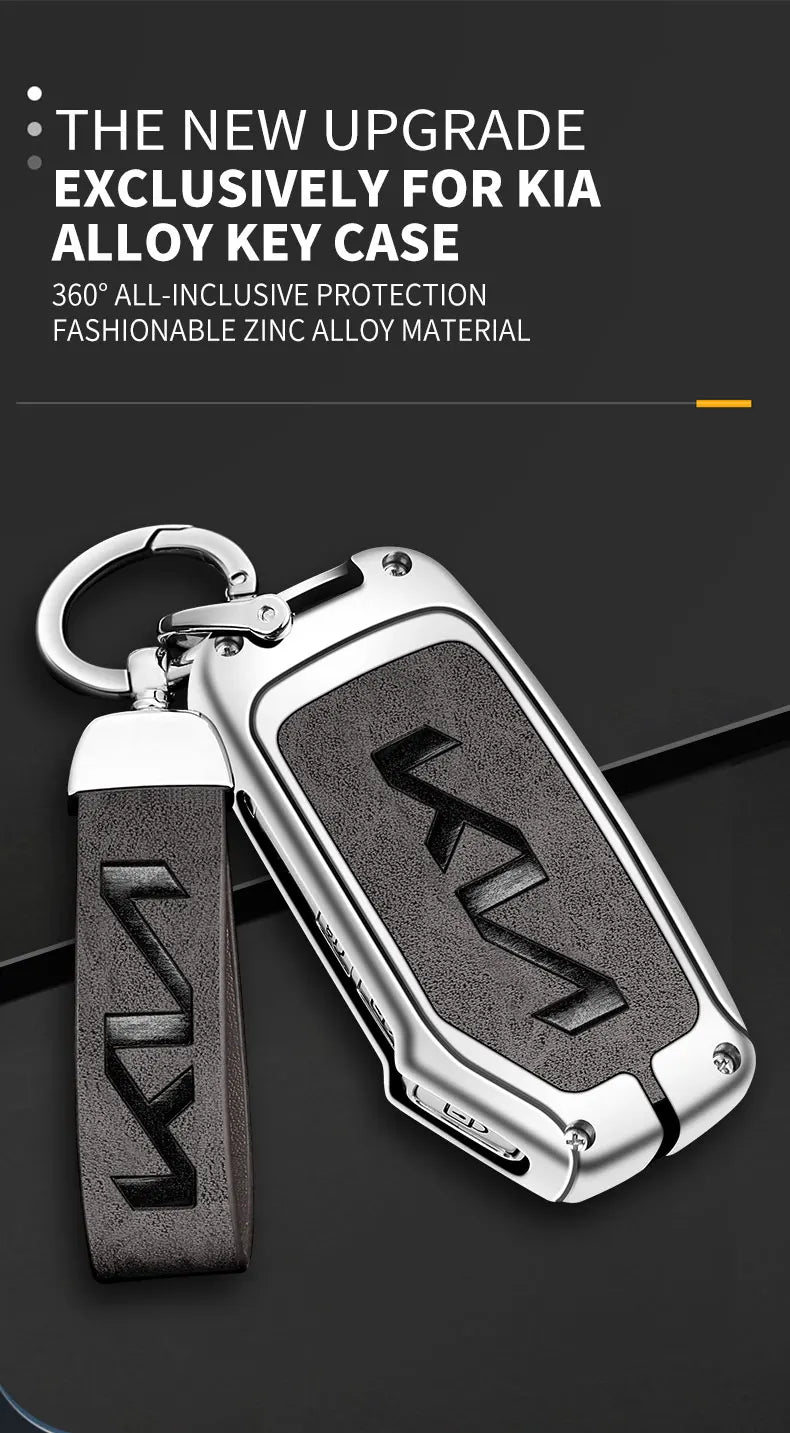A silver alloy car key case with a black leather strap and key fob is shown against a dark background.