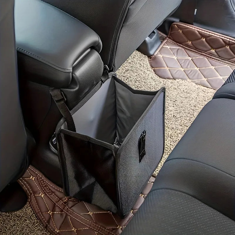 A black car trash organizer with a mesh liner is shown inside a dark gray leather car seat.