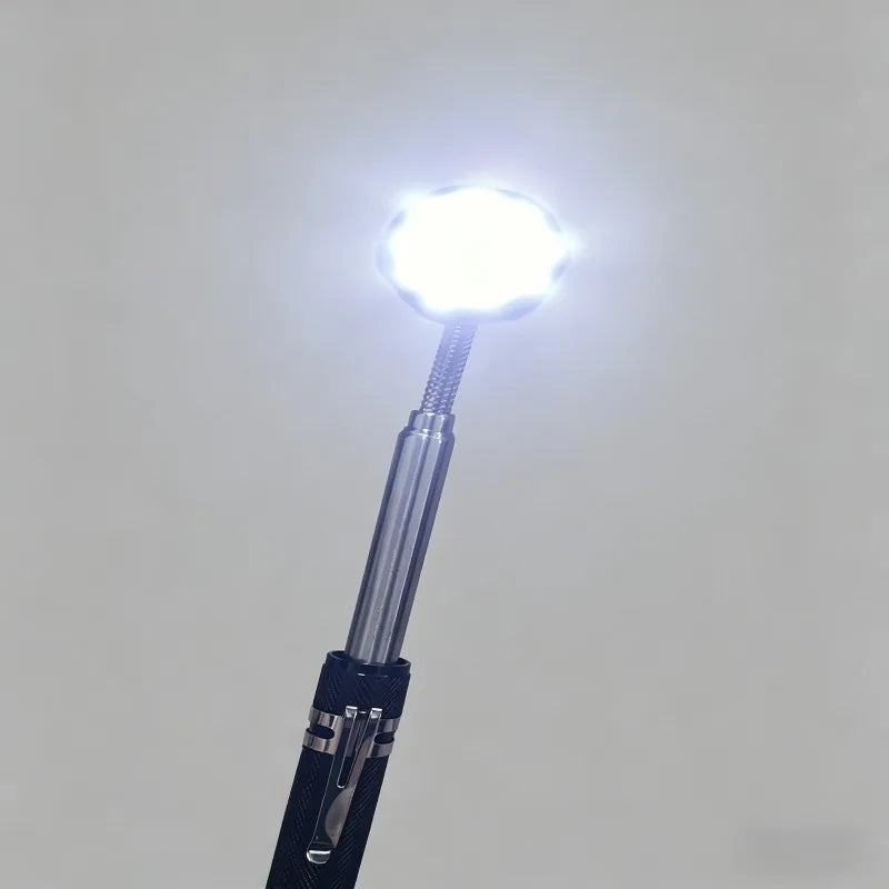 A close-up view of a telescoping magnetic pickup tool with an LED light shining brightly.