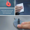 A hand cleans debris and touches a seal strip on a red circular component to ensure proper sealing.