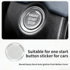 A close-up of a round epoxy decal sticker designed to cover an ignition start stop button for cars.