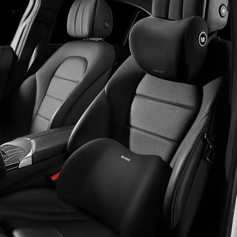 A close-up view of a black universal car headrest neck support pillow installed in a vehicle seat.