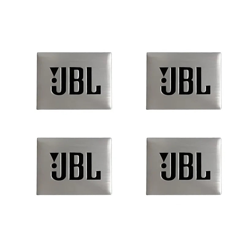 Three square metal emblems with the letters JBL engraved on them.