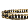 A close-up view of a heavy-duty motorcycle chain with gold-colored links and black O-rings.