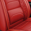 Red leather car seat covers featuring diamond stitching and piping on a seat cushion.