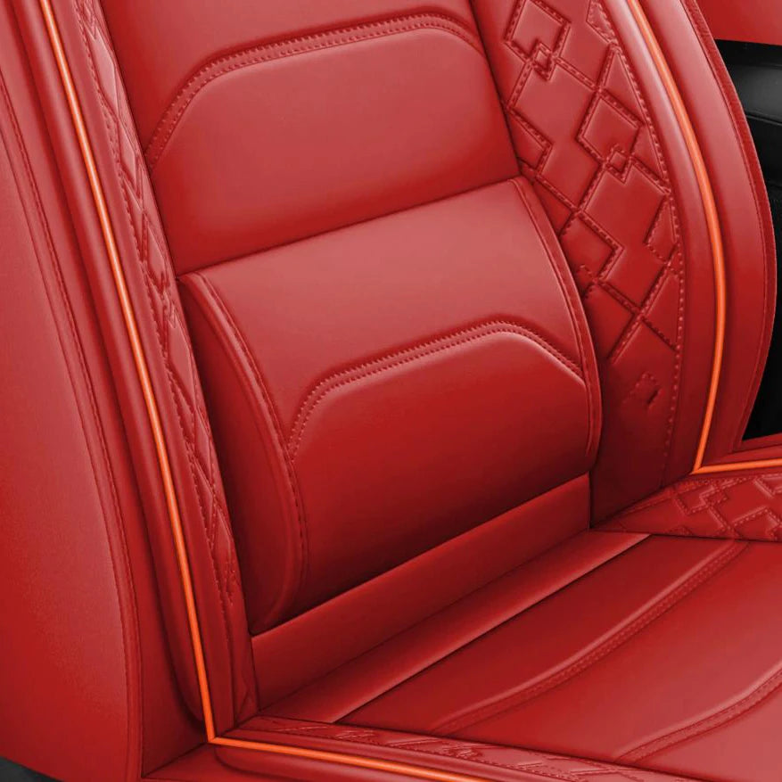 Red leather car seat covers featuring diamond stitching and piping on a seat cushion.