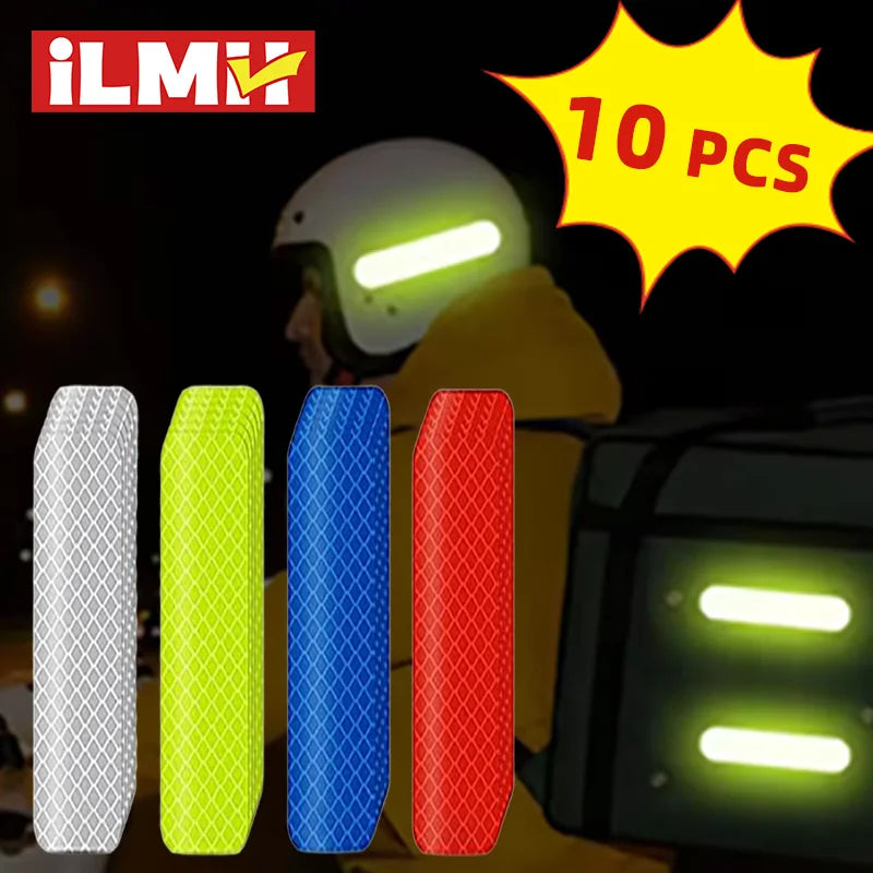 A set of ten reflective safety stickers or tape pieces displayed next to a yellow glove and a dark electronic device.