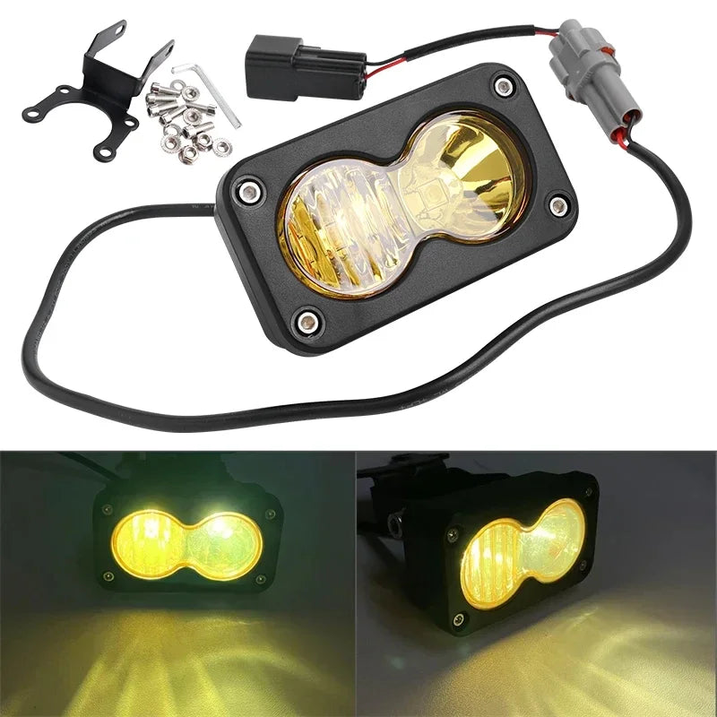 A black LED headlight switch kit with a yellow lens and wiring for a Sur-Ron Segway Talaria.