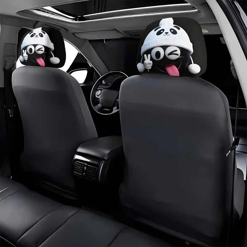 Two black car headrests with white panda face covers are visible in a vehicle interior.