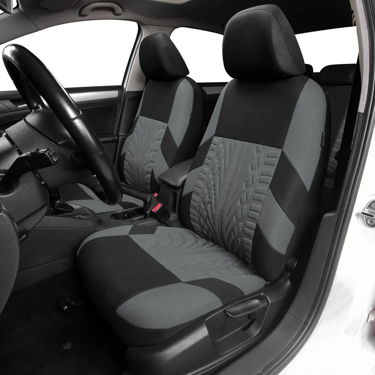 Interior view of a car showing black and gray universal seat covers on the front and rear bench seats.