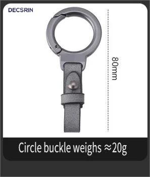 A close-up view of a silver circle buckle keychain with a dark gray strap and a measurement scale.