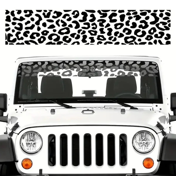 White car windshield covered with a black leopard print sunshade decal.
