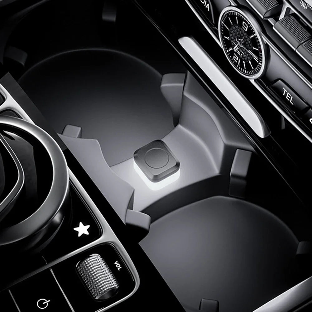 Close-up view of a car interior showing controls and ambient LED lights.