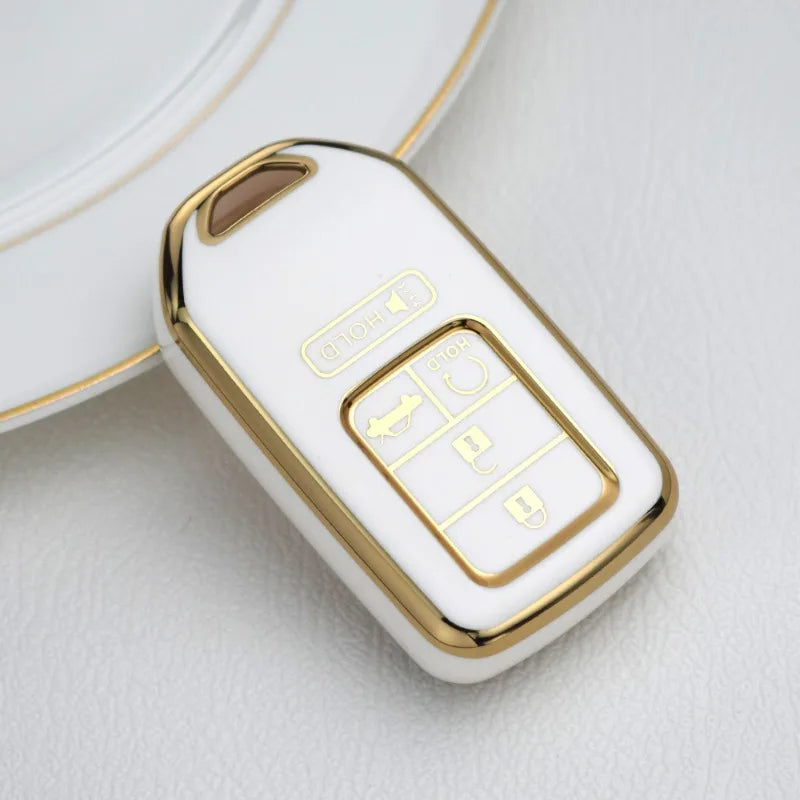 Étui pour clé de voiture en TPU blanc avec accents dorés et plusieurs découpes pour Honda, Toyota et autres véhicules.