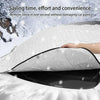 A hand is removing a black car windshield sunshade from a white blanket, demonstrating its ease of use.