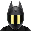 A black full face motorcycle helmet with a reflective yellow visor and pointed horns.