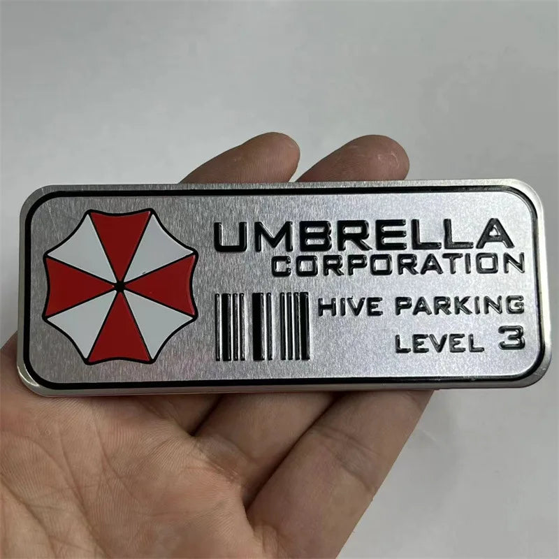 A silver metal decal for hive parking level 3 featuring a red and white umbrella design.