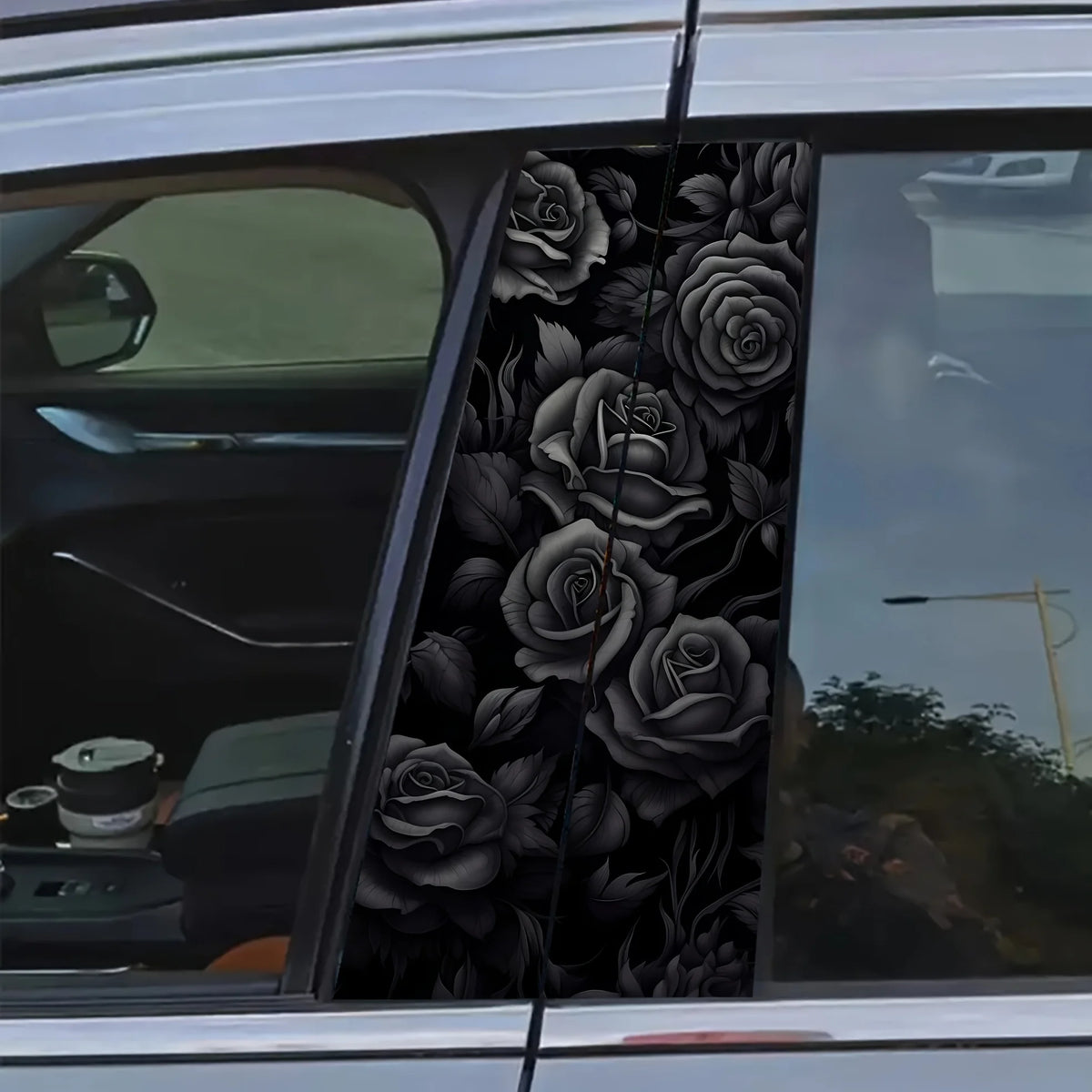 Black rose floral decal set applied to the B-pillar of a car window.