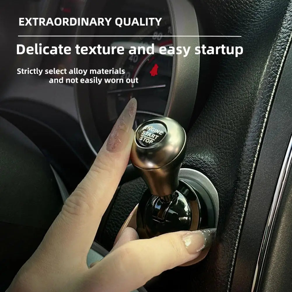A hand is operating an all-metal cylindrical car start button accessory on a vehicle dashboard.