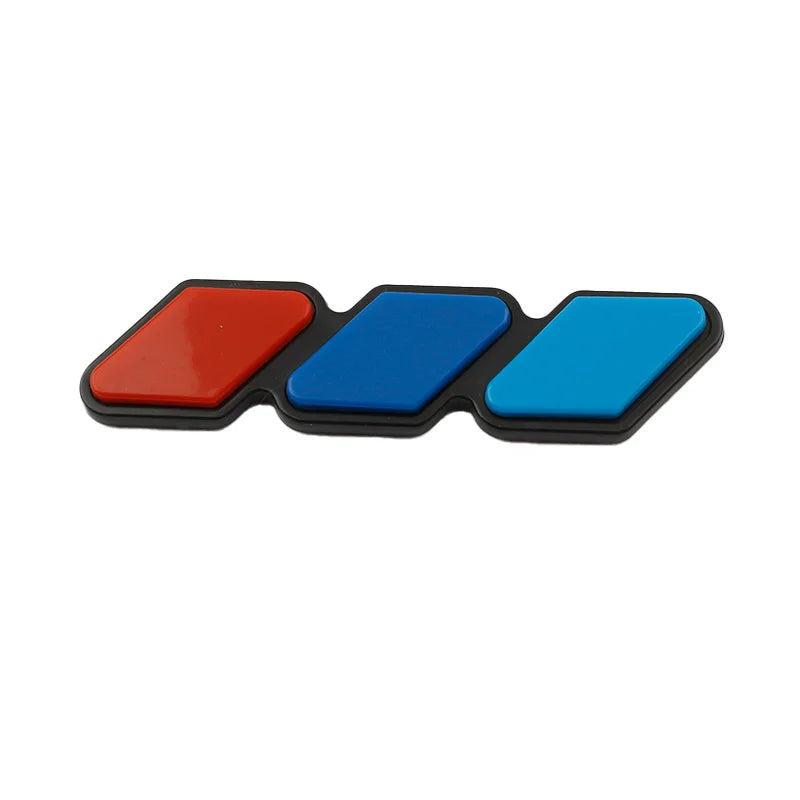 A set of three colored 3D car grill decals in red, blue, and black.